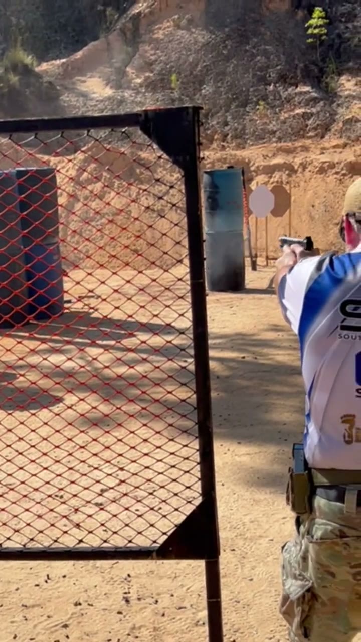 HOBO Shooters competitor engaging targets through a port on a sandy outdoor stage